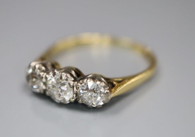 An 18ct and plat set three stone diamond ring, size M/N, gross 2.8 grams,